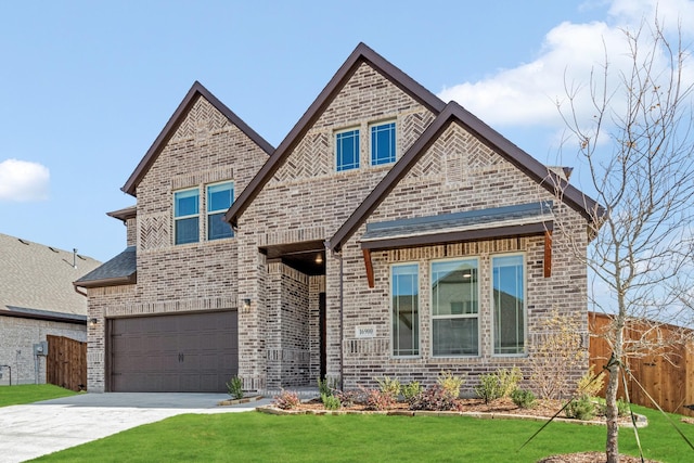 craftsman-style home featuring a garage and a front lawn