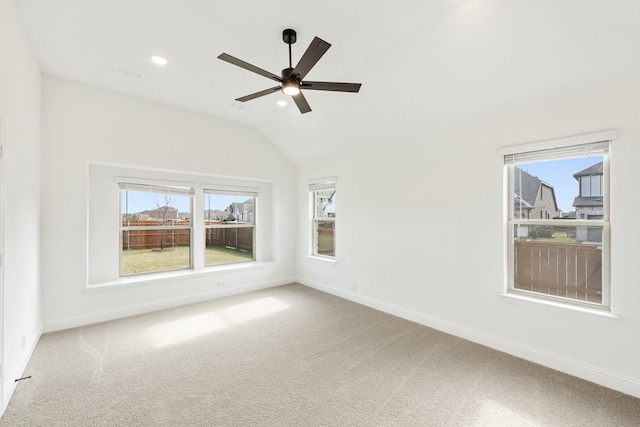 spare room featuring ceiling fan, carpet floors, and vaulted ceiling