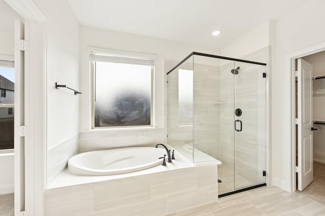 bathroom featuring separate shower and tub