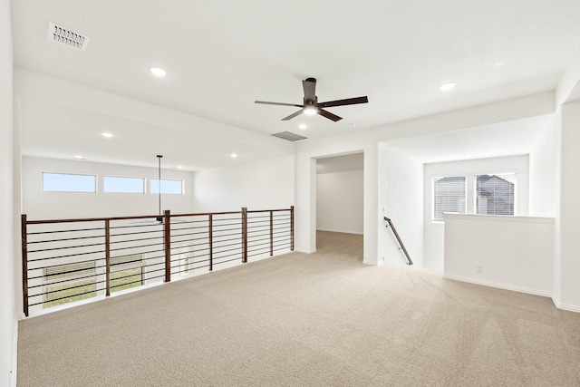 carpeted empty room featuring ceiling fan