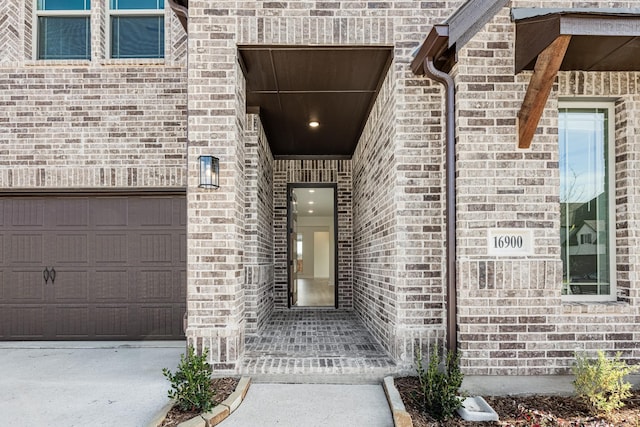 view of exterior entry with a garage