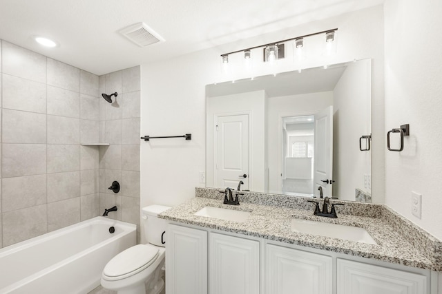 full bathroom featuring toilet, vanity, and tiled shower / bath