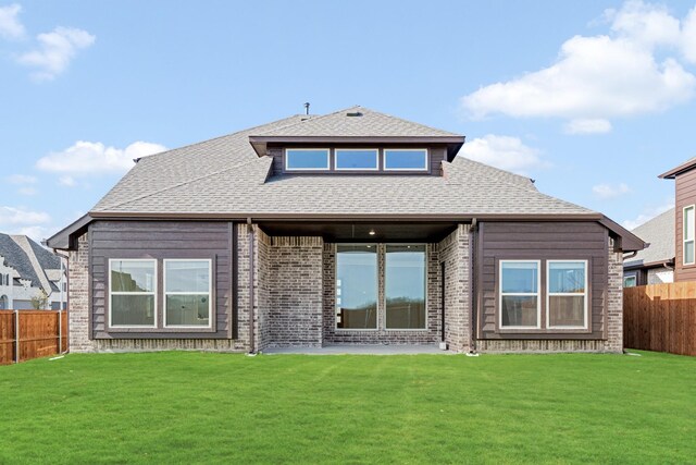 rear view of property featuring a yard