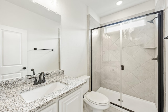 bathroom featuring vanity, toilet, and an enclosed shower