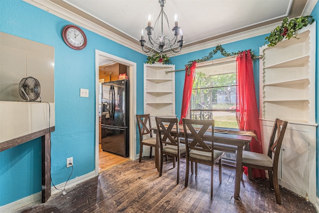 dining space with ornamental molding, hardwood / wood-style floors, and a chandelier