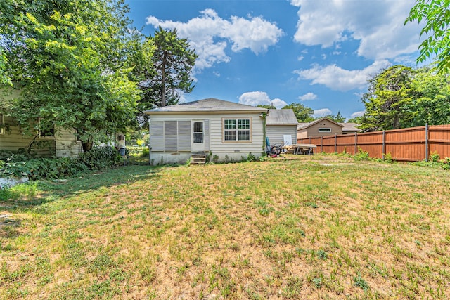 back of house featuring a lawn