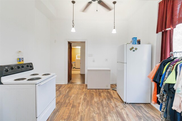 kitchen featuring ceiling fan, light wood-type flooring, white appliances, and hanging light fixtures