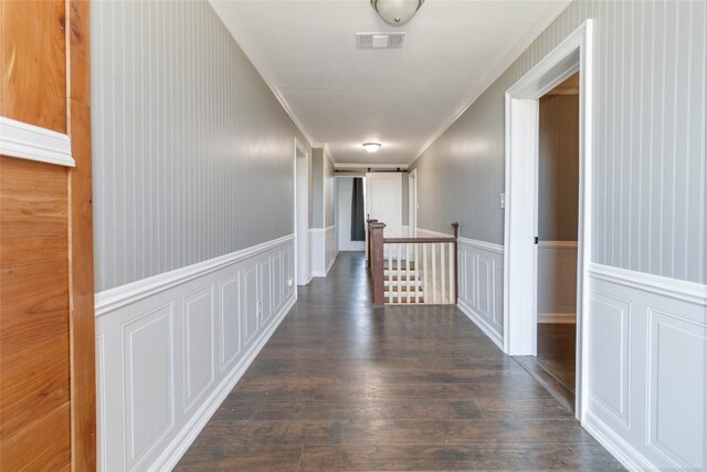 hallway with ornamental molding and dark hardwood / wood-style floors