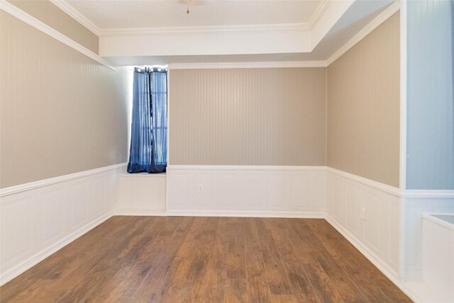 empty room with crown molding and hardwood / wood-style flooring