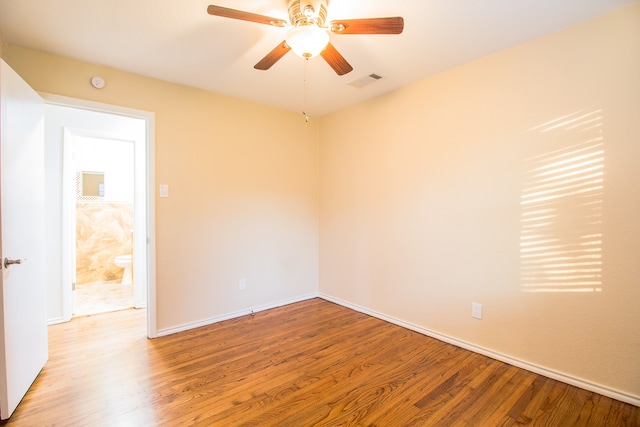 empty room with ceiling fan and wood-type flooring