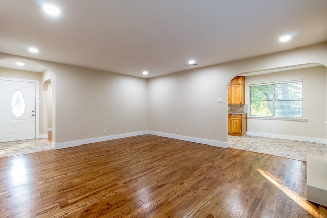 unfurnished living room with wood-type flooring