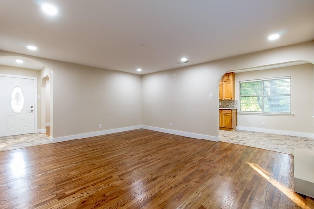 unfurnished living room featuring dark hardwood / wood-style floors