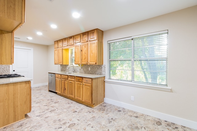 kitchen featuring sink, tasteful backsplash, dishwasher, and light tile patterned floors