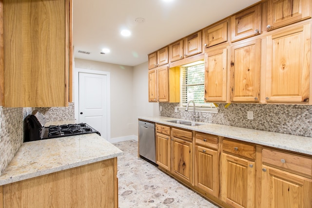 kitchen with sink, stainless steel dishwasher, backsplash, and light stone countertops