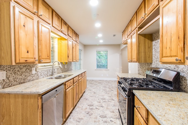 kitchen featuring decorative backsplash, appliances with stainless steel finishes, light stone counters, and light tile patterned floors