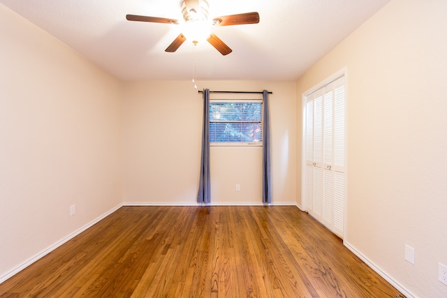 unfurnished room featuring hardwood / wood-style floors and ceiling fan