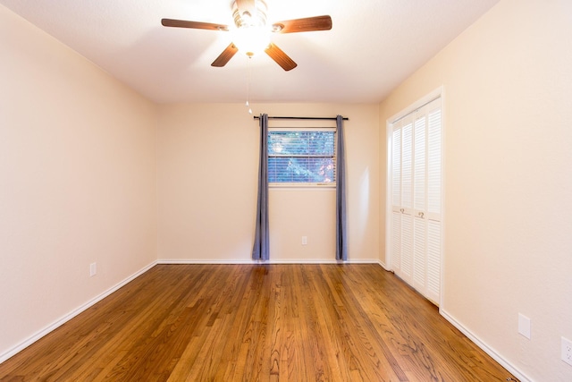 unfurnished room with hardwood / wood-style flooring and ceiling fan