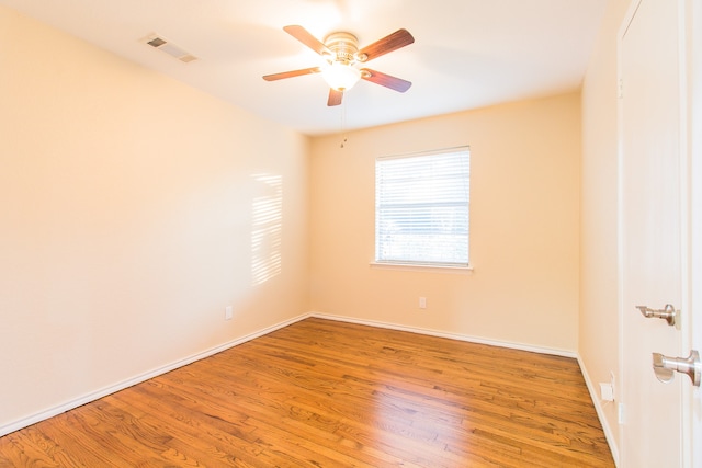 empty room with ceiling fan and hardwood / wood-style floors