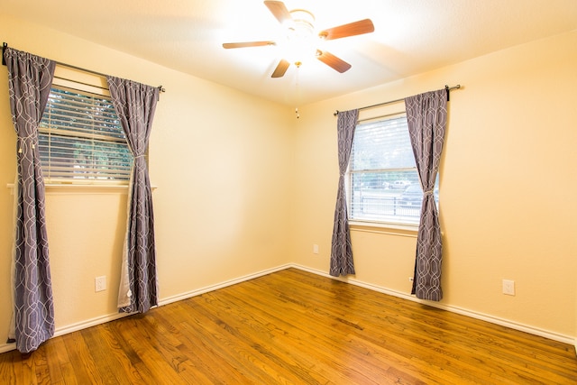 empty room featuring ceiling fan and wood-type flooring