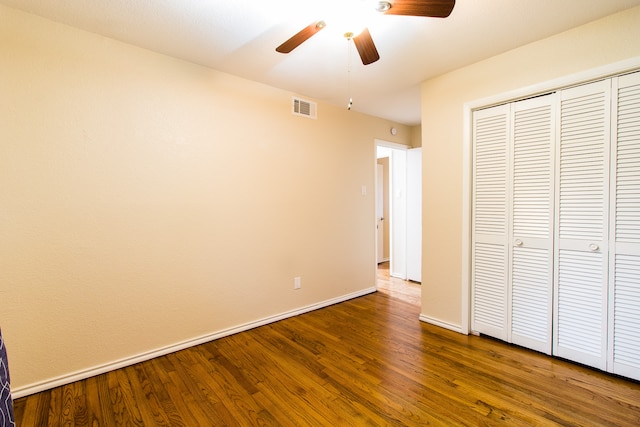 unfurnished bedroom with hardwood / wood-style flooring, a closet, and ceiling fan