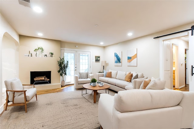 living room with light wood-type flooring and french doors