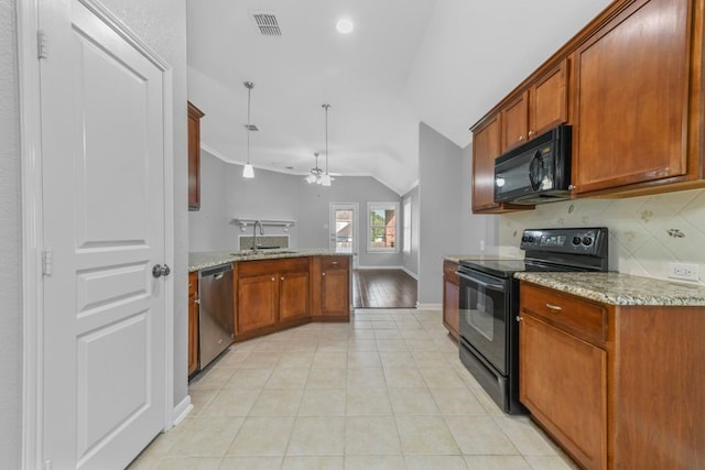 kitchen with black appliances, lofted ceiling, light stone countertops, and light hardwood / wood-style floors