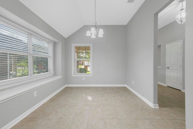 tiled spare room with a chandelier and lofted ceiling