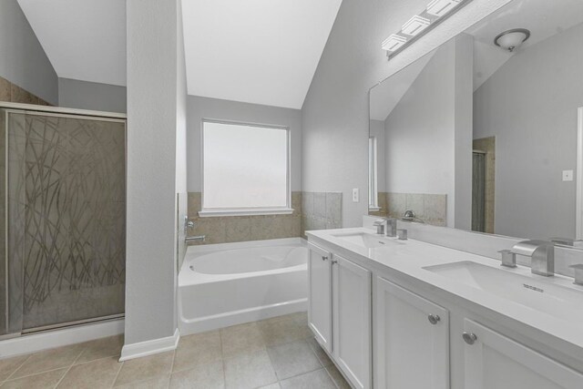 bathroom featuring lofted ceiling, dual bowl vanity, tile patterned flooring, and separate shower and tub