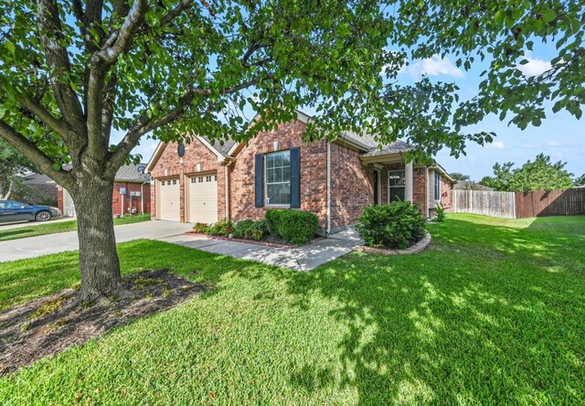 view of front of property with a garage and a front yard