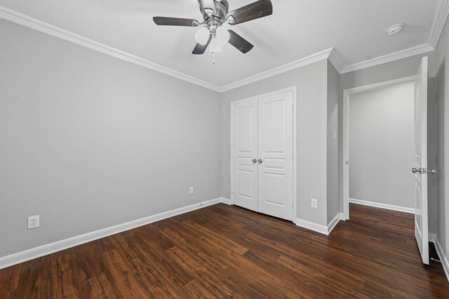 unfurnished bedroom featuring ceiling fan, a closet, hardwood / wood-style flooring, and crown molding