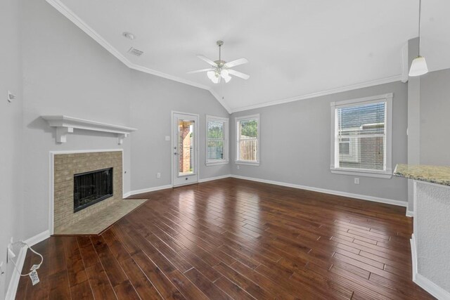 unfurnished living room featuring ceiling fan, dark wood-type flooring, plenty of natural light, and crown molding