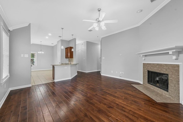 unfurnished living room featuring ceiling fan, tile patterned floors, and crown molding