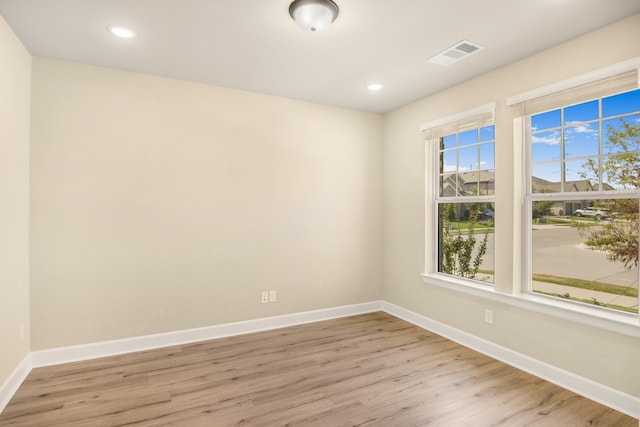 spare room with light hardwood / wood-style floors