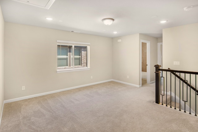 unfurnished room with light carpet