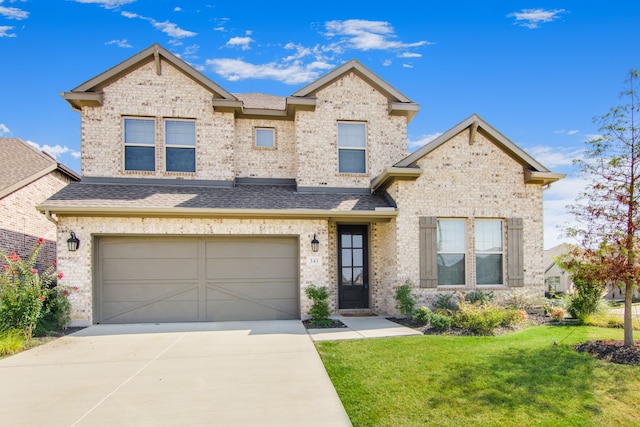 view of front facade featuring a front lawn and a garage