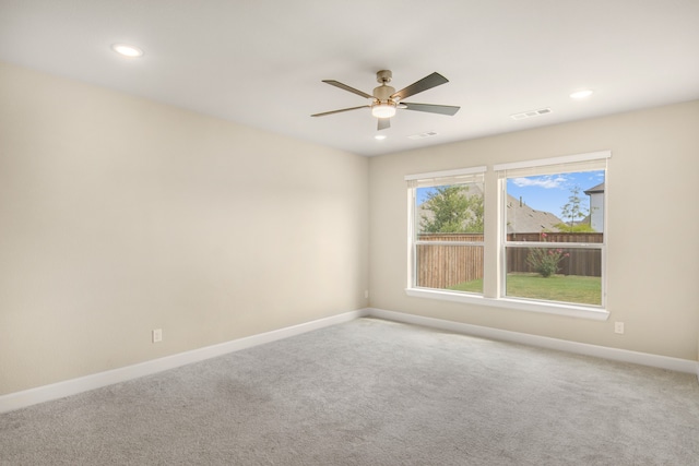 carpeted empty room featuring ceiling fan