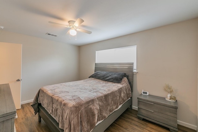 bedroom featuring ceiling fan, baseboards, and dark wood-type flooring