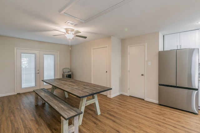 dining area featuring light wood-type flooring, baseboards, visible vents, and french doors