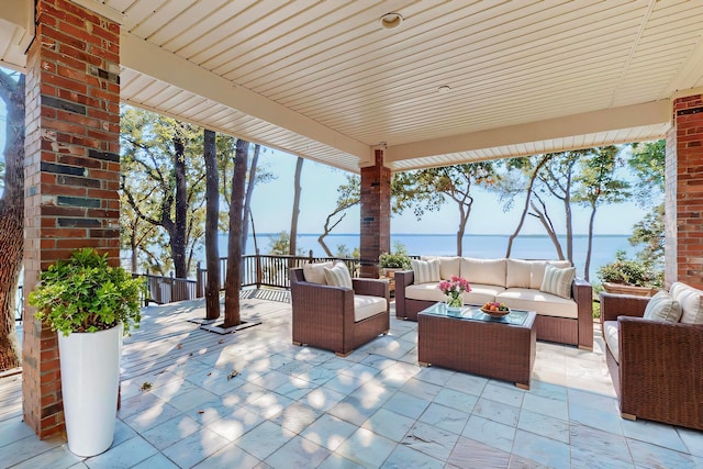 view of patio featuring outdoor lounge area and a water view