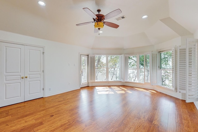 empty room featuring lofted ceiling, ceiling fan, and light hardwood / wood-style floors