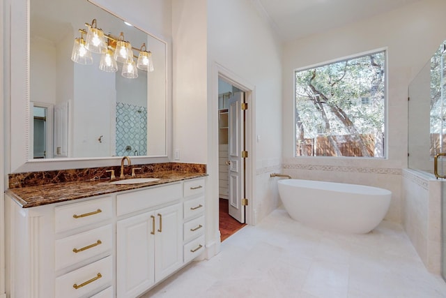 bathroom with tile walls, vanity, and independent shower and bath