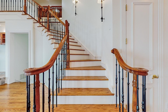 staircase with hardwood / wood-style flooring