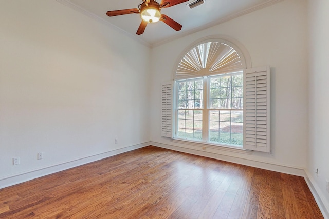 empty room featuring crown molding, hardwood / wood-style floors, and ceiling fan