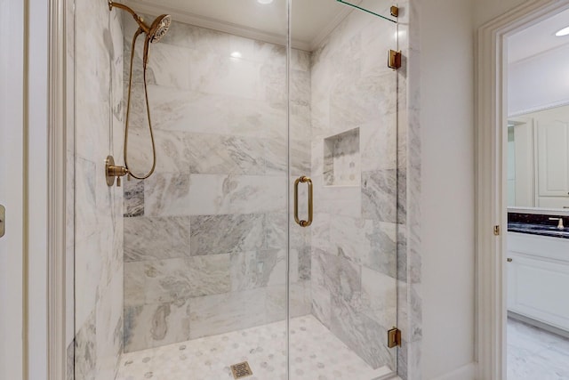 bathroom with a shower with shower door and crown molding