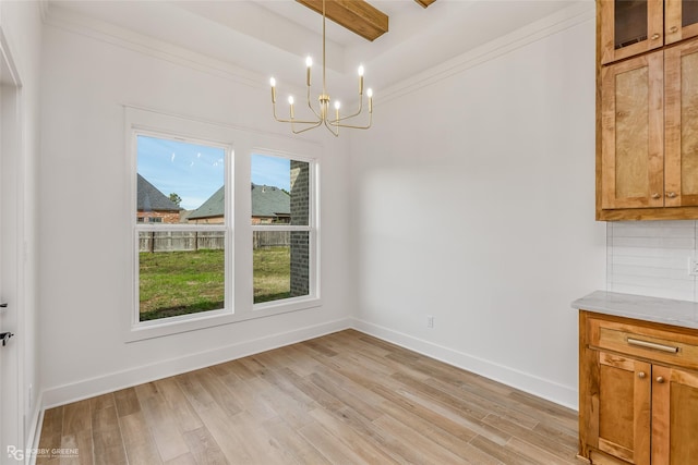 unfurnished dining area featuring beam ceiling, light hardwood / wood-style floors, and a chandelier