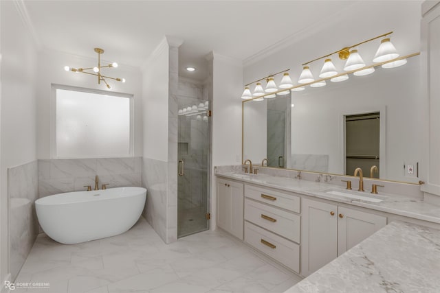 bathroom with tile walls, independent shower and bath, vanity, crown molding, and a notable chandelier