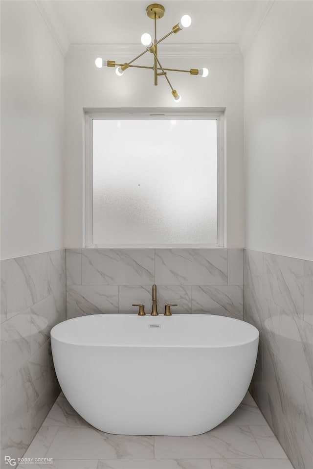 bathroom with a bath, ornamental molding, and tile walls