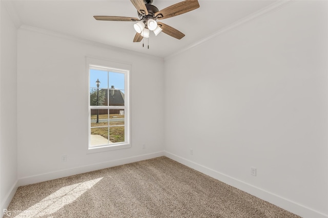 carpeted spare room featuring ceiling fan and crown molding