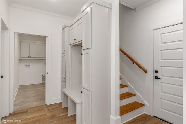 mudroom featuring ornamental molding and light hardwood / wood-style floors