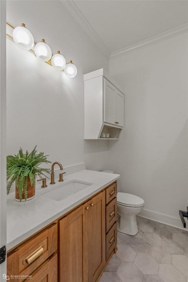 bathroom with vanity, tile patterned floors, ornamental molding, and toilet